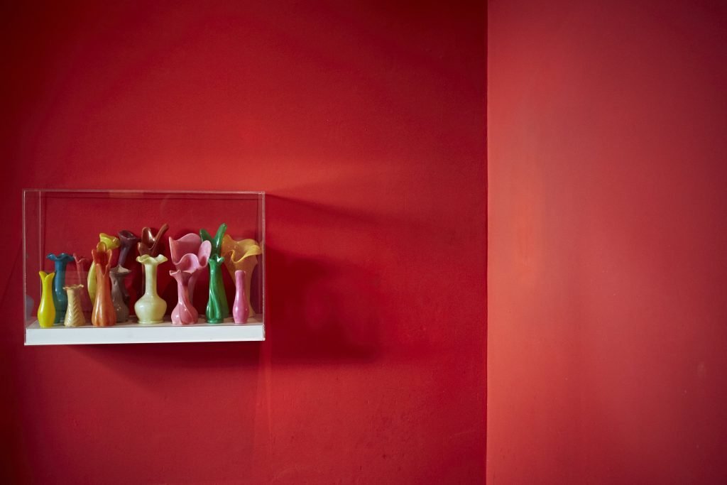 Jane Simpson - Art at El Fenn - ceramics enclosed in a glass frame on a red wall