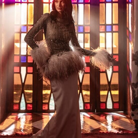 woman in wedding dress standing in front of stained glass windows